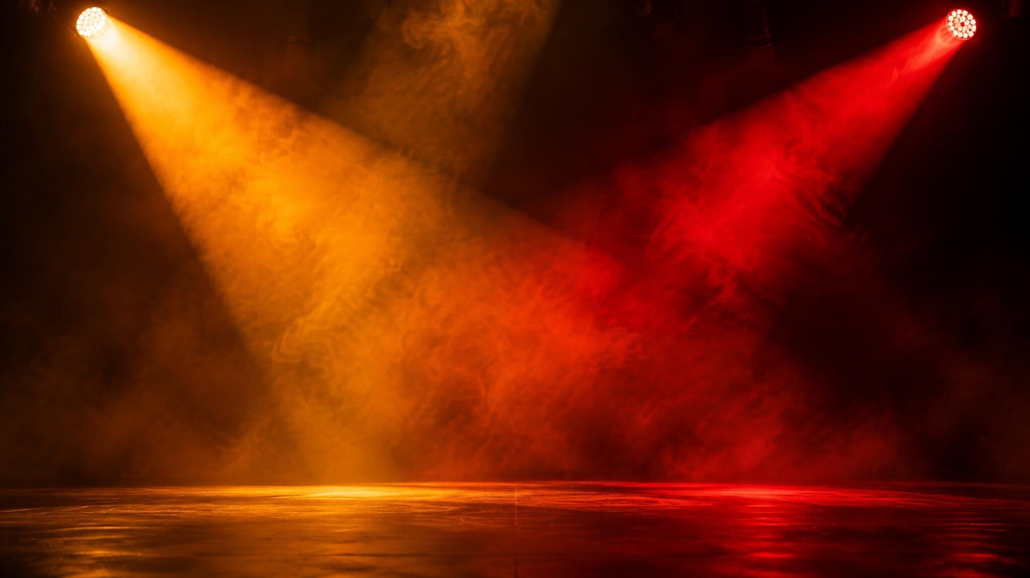 Coloured spotlight beams creating mood on an empty stage